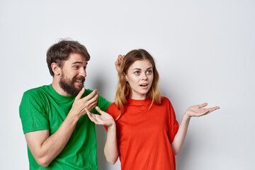 a young couple multicolored t-shirts communication quarrel studio lifestyle