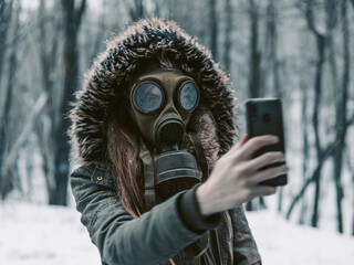 Creepy woman in gas mask taking self portrait