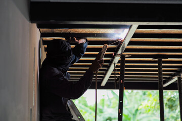 Side view of worker welding the steel structure by the electrical welding machine