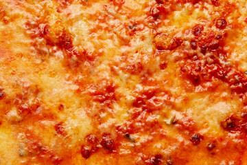 Closeup of caramelized cheese crust on traditional Italian bolognese pizza