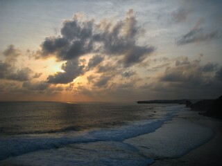 Obraz premium Sunset and clouds at Depok beach, Yogyakarta, Indonesia