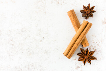 Food Background with Ceylon Cinnamon Sticks and Star Anise on White Speckled Background