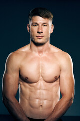 Fototapeta na wymiar athletic male topless workout muscle bodybuilder dark background
