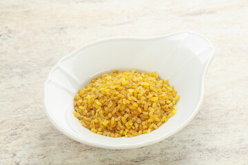 Raw bulgur in the bowl