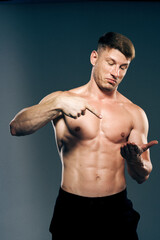 Fototapeta na wymiar man with muscular torso workout fitness dark background