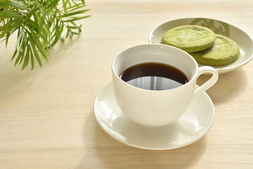 A cup of coffee on a wooden table