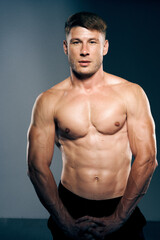Fototapeta premium athletic male topless workout muscle bodybuilder dark background