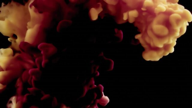 Slow motion: two ink clouds (red, yellow) splashing down and getting mixed into a water tank, over a black background.
