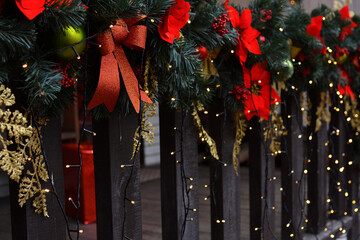 A beautifully decorated wooden fence with Christmas decorations. Christmas mood. Happy New Year and...