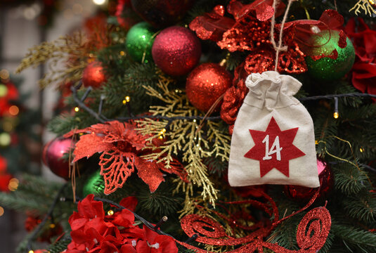 Christmas background. Advent calendar in the form of an eco bags hangs on the background of a Christmas porch.Christmas gifts and tasks
