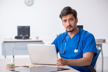 Young male doctor working in the clinic