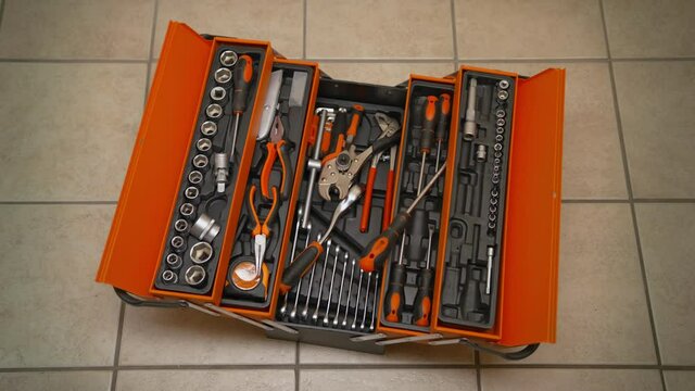 The plumber finished his job and threw the tools into the toolbox. 