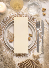Boho Wedding Table place with vertical Blank card on plate near pampas grass