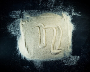 Greek letter eta written on the white sand with black background