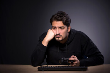 Young male gamer on grey background © Elnur