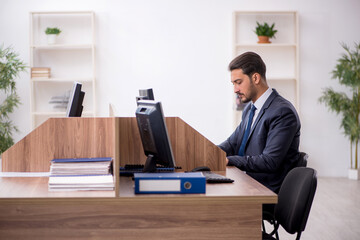 Young male employee working in the office