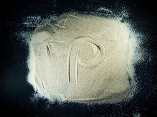 Greek letter rho written on the white sand with black background