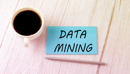 DATA MINING text on the blue sticker with cofee and pen