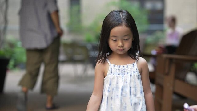 Asian scolded and angry girl walking around throwing a tantrum, portrait