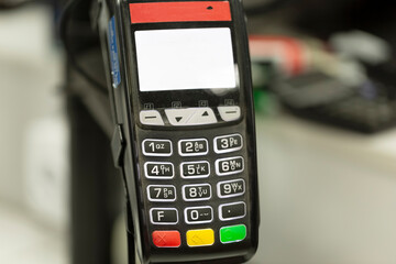 Pay pass payment terminal by card or smartphone close-up in a store or restaurant