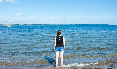 single woman at front of Baltic sea