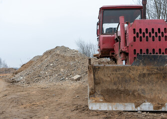 Photo of a Soviet bulldozer mountains of sand and stones in the background