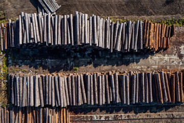 Log storage for sawn timber for export. Lumberjack port business concept. Aerial top view
