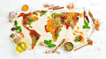 World map made of different spices on a white wooden background. Top view.