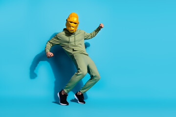 Obraz na płótnie Canvas Photo of carefree active crazy dancer unusual performance wear gorilla mask sportswear isolated blue color background