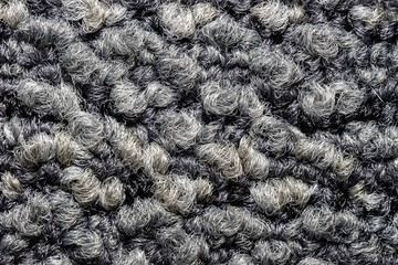 Seamless close up of monochrome grey carpet texture background from above.