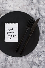 Get your fiber in text on dining plate with fork and knife, healthy nutrition and research about the microbiome