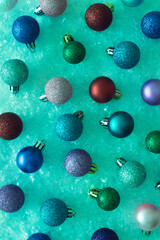 Christmas colorful ornament background in vibrant bold green holographic color. Surreal dark trendy wallpaper.