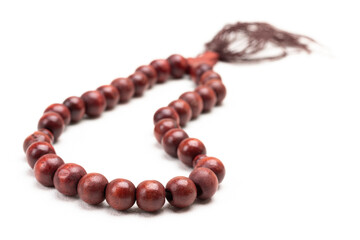 Brown rosary on white.