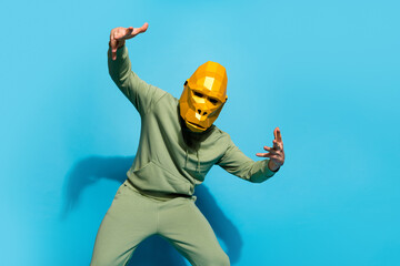 Photo of entertainer funky ape baboon dance have fun wear sportswear gorilla mask isolated blue...
