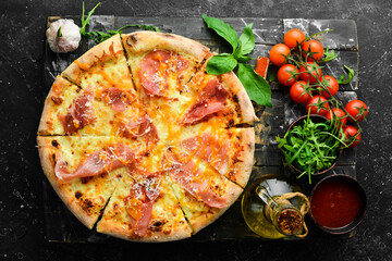 Delicious pizza with cheese and prosciutto. Top view. Food delivery.