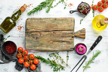 White wooden background of cooking. Spices and vegetables. Top view. Free space for your text.