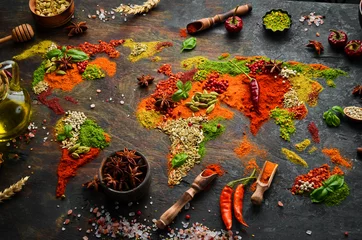 Zelfklevend Fotobehang Spice banner. The map of the world is made of various spices and seasonings on a dark background. Top view. © Yaruniv-Studio