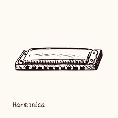 Harmonica. Ink black and white doodle drawing in woodcut style with inscription.