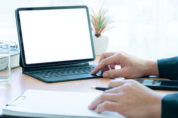 Businesswoman using portable tablet and document at office.