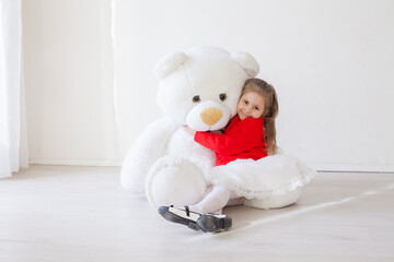 beautiful girl with toy teddy bear on white