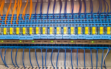 Group of relays in a row in electrical cabinet of automation control industrial system