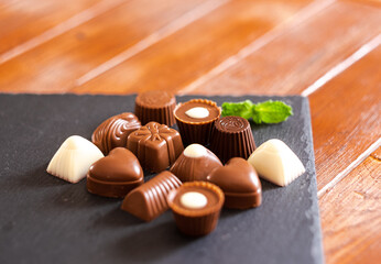 assorted chocolates on a black base, milk chocolate, dark and white