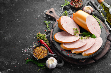 Boiled chicken sausage with spices and herbs. Top view. Free space for text. © Yaruniv-Studio