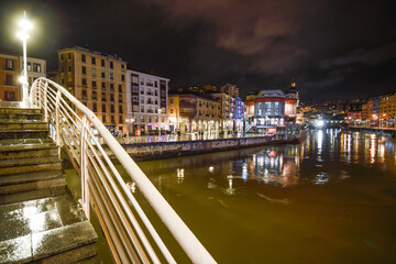 Footbridge of the Ribera bridge in Bilbao at dusk and raining