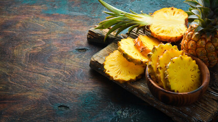sliced juicy pineapples. Ripe baby pineapple. Tropical fruits. Top view. Free space for text.