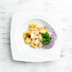 Marinated mushrooms with onions and vinegar, on a plate. Restaurant menu. Top view.