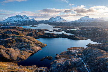 Fototapeta na wymiar Scottish Highlands: Pristine Highland landscape in winter with 3 prominent mountains and lochs 