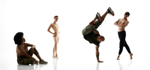 Three dancers looking on dancing male break dancer