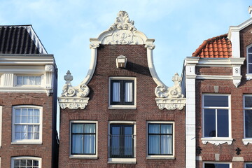 Fototapeta na wymiar Historic Canal House Decorated Bell Gable Close Up in Amsterdam, Holland