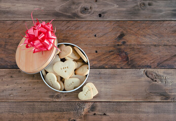 Open cookie box on wooden background. Copy space. Valentine's Day.